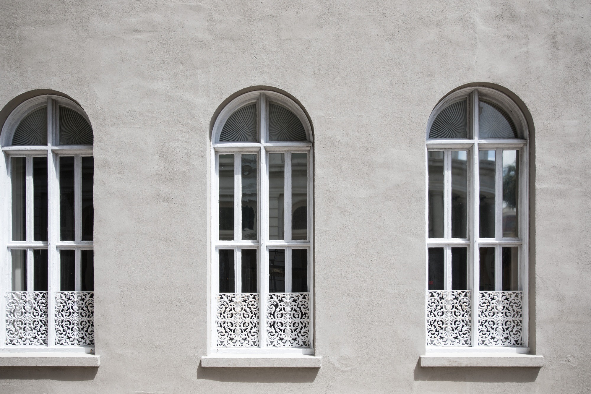 Arched windows soft grey in colour bright sun