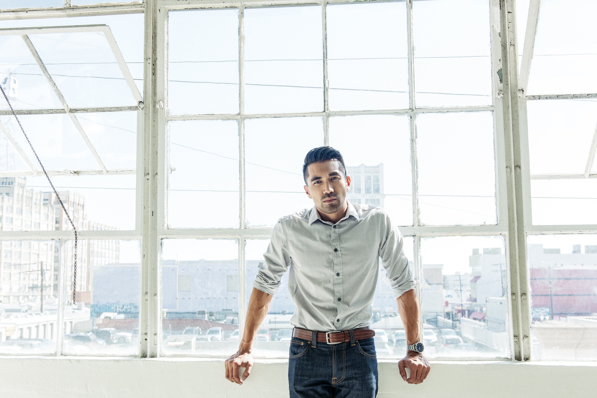 Businessman leaning against office window