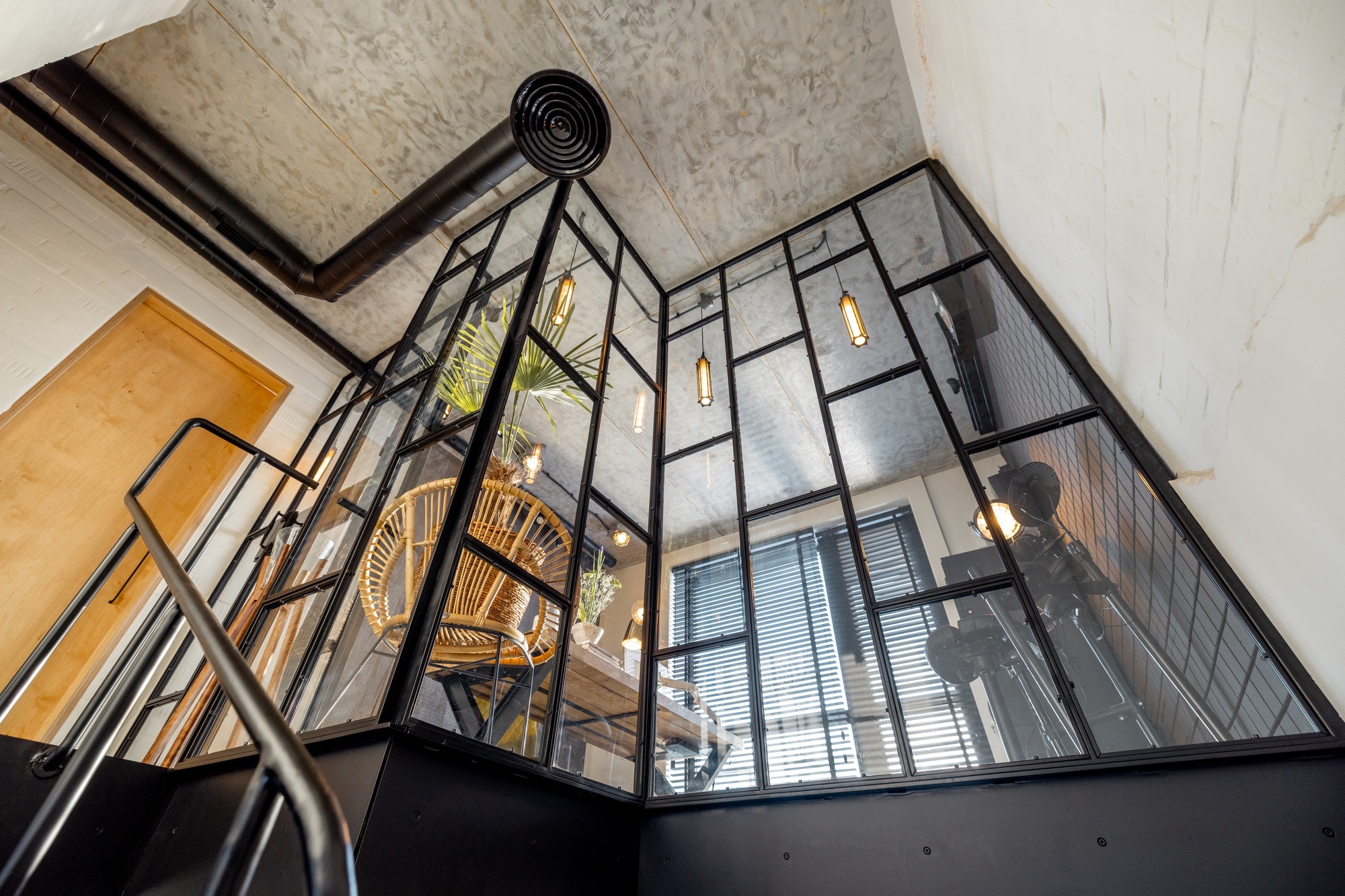 Glass partition to the home office in loft style